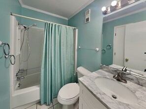 A bathroom with a bathtub, shower, toilet, and sink. - Pam's Paradise (Carolina Beach)