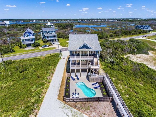 A large two-story house with a swimming pool and a deck area. - Good Tide-ings (Sneads Ferry)