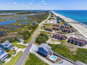 A coastal residential area with beachfront properties, a road, and a pier. - Good Tide-ings (Sneads Ferry)