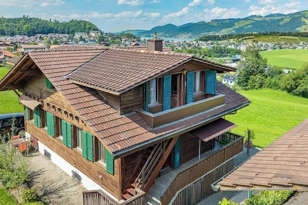 Exterior view of the chalet surrounded by nature and open fields
