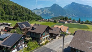 Un quartier résidentiel avec des maisons, une rue et un paysage montagneux en arrière-plan.