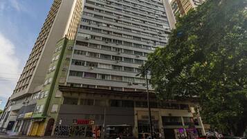 A multi-story building with a ground-level commercial space, including a restaurant and a shop.
