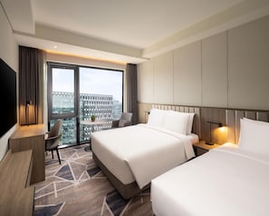 A hotel room with two beds, a desk, a chair, a TV, and a large window with a city view. - Hyatt Place Seoul Pangyo (Seongnam)