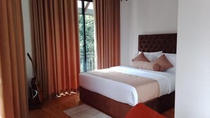 A bedroom with a bed, curtains, a guitar, and a view of greenery outside. - The Lipton View Inn (Bandarawela)
