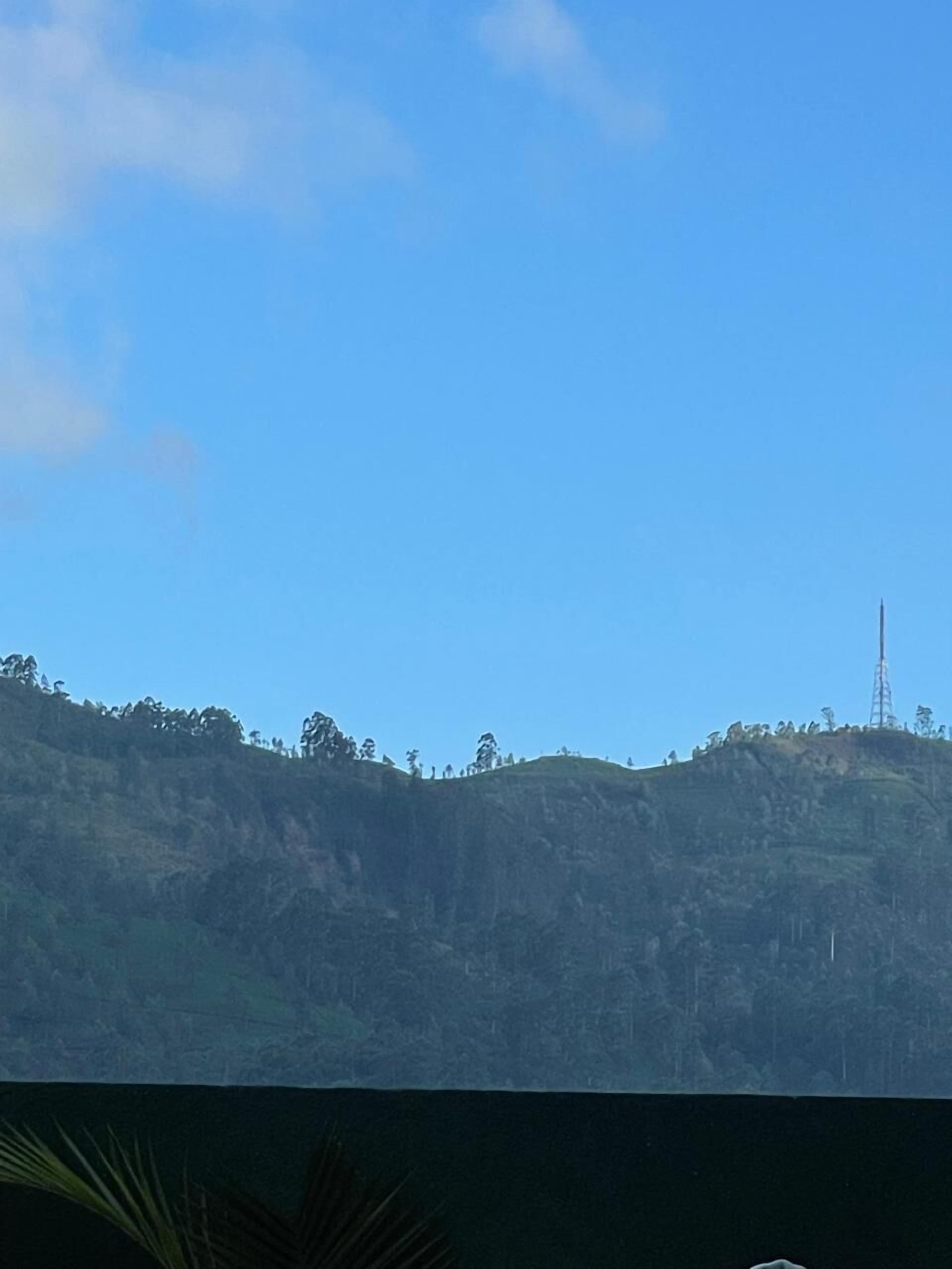 A view of a hilly landscape with a clear sky.