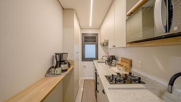 Apartment | Private kitchen | Fridge, microwave, stovetop, cookware/dishes/utensils