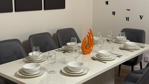 A dining table set with plates, bowls, and wine glasses, surrounded by chairs. - 3-bedroom house in beautiful Citrus Heights (Citrus Heights)