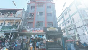 A multi-story building with a storefront at the ground level. - MCP Transient near NAIA (Pasay)