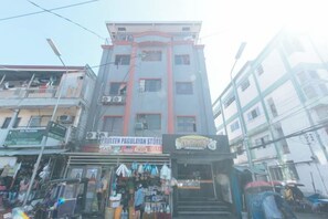 A multi-story building with a commercial ground floor featuring a store named 'PAULEEN PAGULAYAN STORE' and a sign for 'TAPAS'. - MCP Transient near NAIA (Pasay)