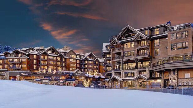 A multi-story lodge with a snow-covered ground, featuring balconies and large windows. - Luxury 1-Bedroom Condo at Grand Colorado on Peak 8 — Ski-In/Ski-Out! (Breckenridge)