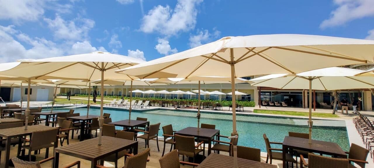 A poolside area with outdoor seating and umbrellas.