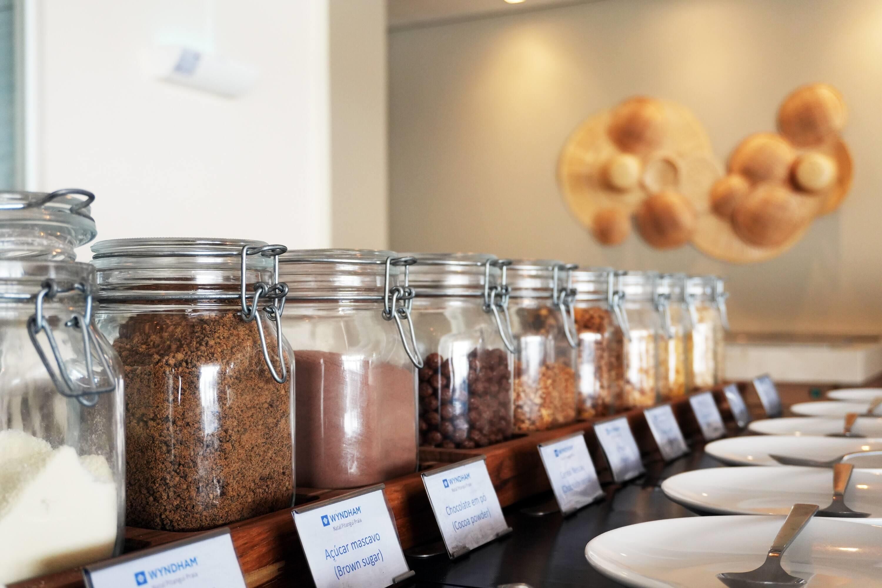 A food display with labeled containers of various ingredients.