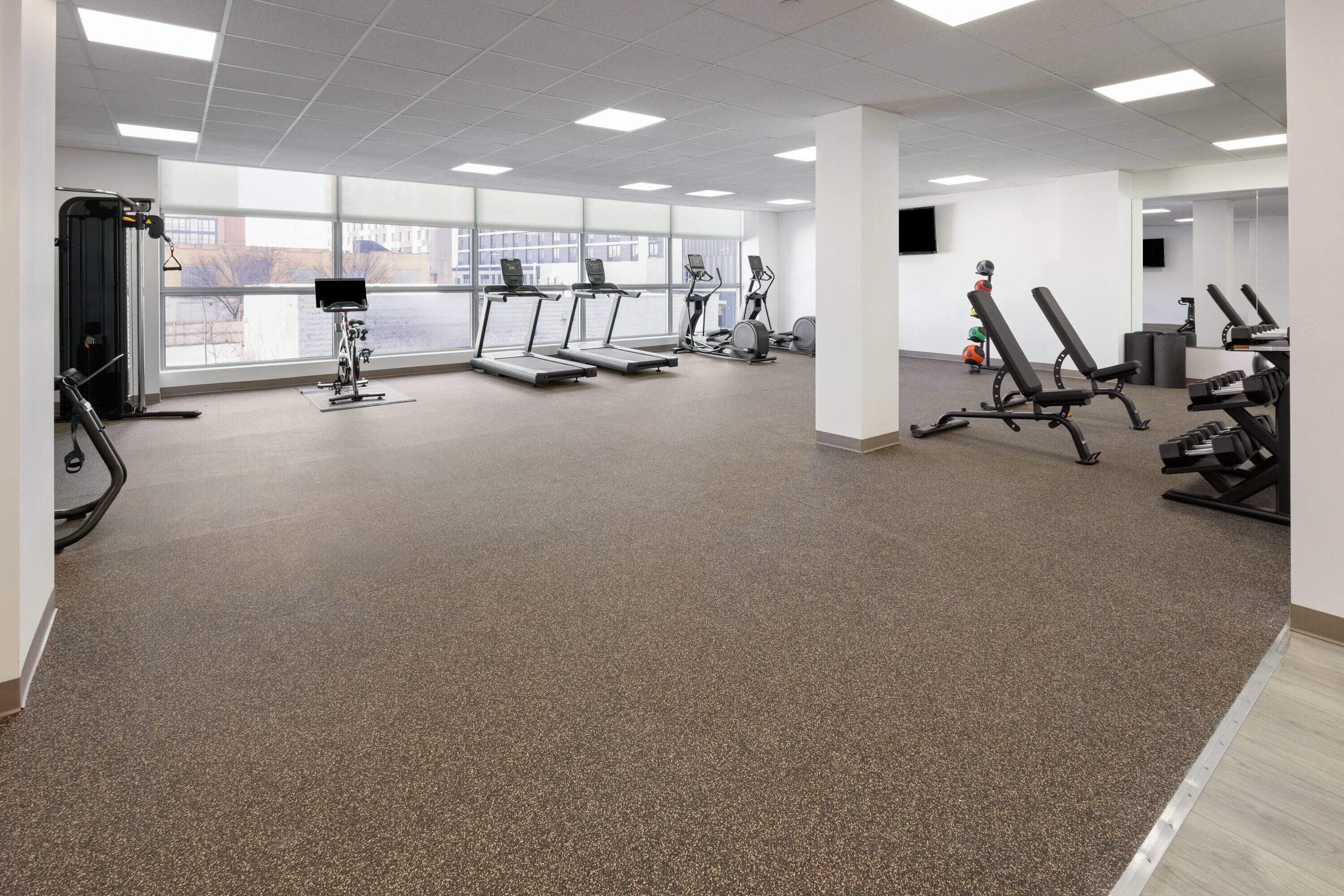A gym with treadmills, stationary bikes, and weight machines.