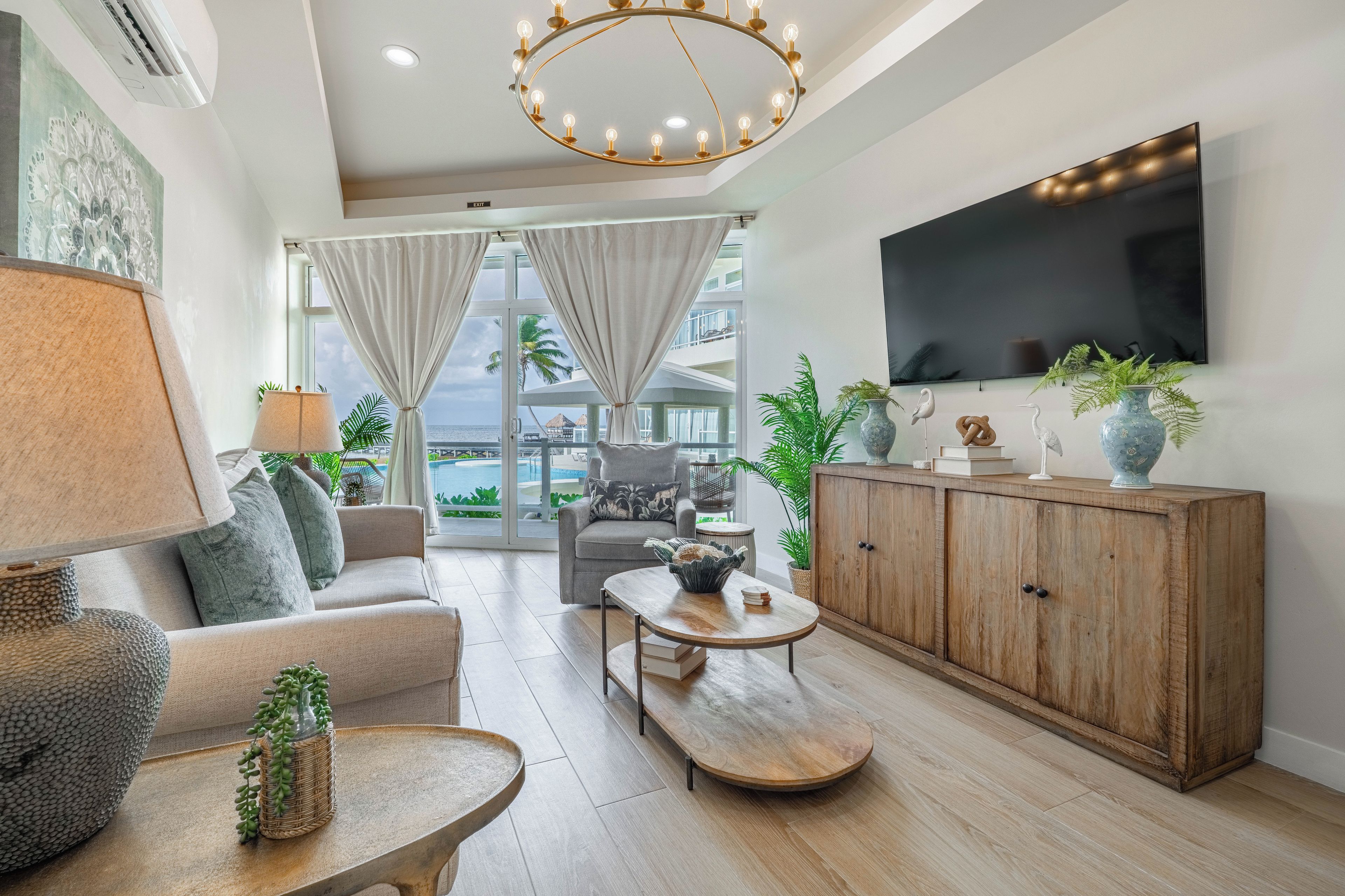 A modern living room with a sofa, coffee table, and TV.