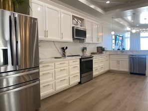 Fridge, microwave, oven, stovetop - Styles Beach 1D - Luxury Beachfront Condo w/ Pool (San Pedro)