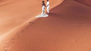 A desert landscape with sand dunes and a large moon in the sky. - Merzouga white camp  (Merzouga)