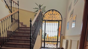 A staircase with a wrought iron railing leading to a gated entrance.