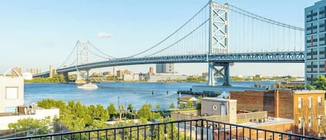 A bridge over a river with buildings in the background.