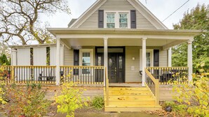 A two-story house with a front porch, a black front door, and a small window above the door. - 2 Mi to Dtwn: Charming Sandusky Getaway w/ Hot Tub (Sandusky)