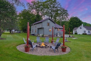 A house with a fire pit and outdoor seating.