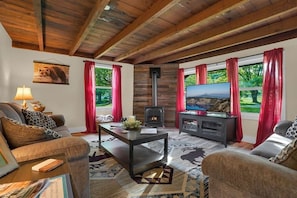 A cozy living room with a fireplace, comfortable seating, and a television.