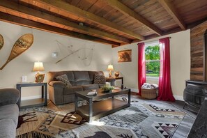 A cozy living room with a sofa, coffee table, and fireplace.