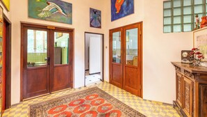 A hallway with wooden doors, a checkered floor, and a rug. - Your private retreat in the heart of Bohemia, in the middle of the natural paradise of Křivoklátsko (Velká Buková)
