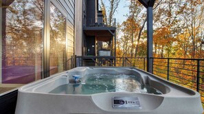 A hot tub on a balcony with a view of autumn trees. - Smoky Mountain Cabin With Indoor Pool + Hot Tub + Views Dolly's Dreamhouse by Avantstay (Sevierville)