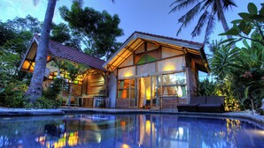 A modern house with a swimming pool, large windows, and tropical plants. - Villa Samalama Gili Air (Pemenang)