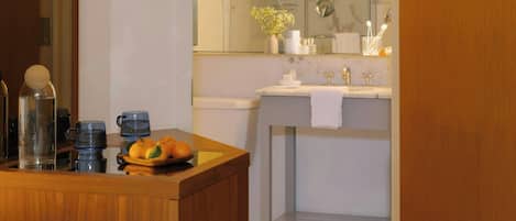 A modern bathroom with a wooden vanity, a large mirror, and a glass shower enclosure.