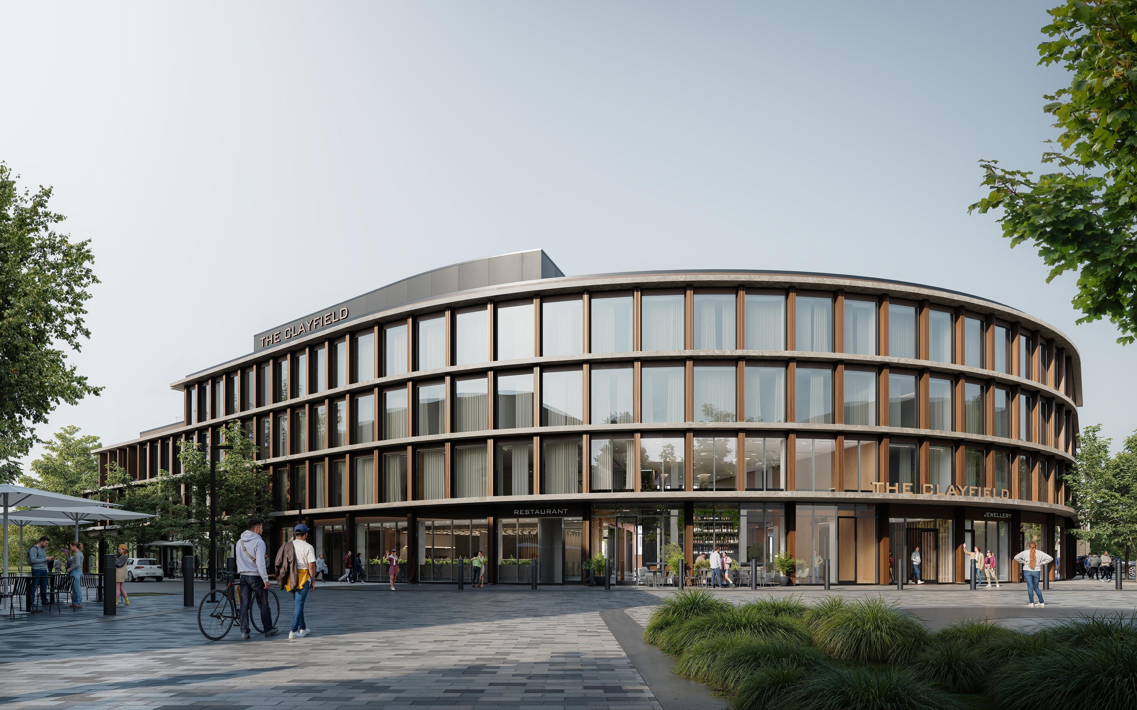 A modern building with a curved facade, labeled 'The Clayfield.' It includes a restaurant and a jewellery store.