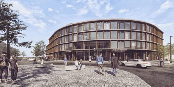 A modern building with a curved facade, a central entrance, and a paved plaza with seating. - The Clayfield, in the Unbound Collection by Hyatt (Niagara-on-the-Lake)