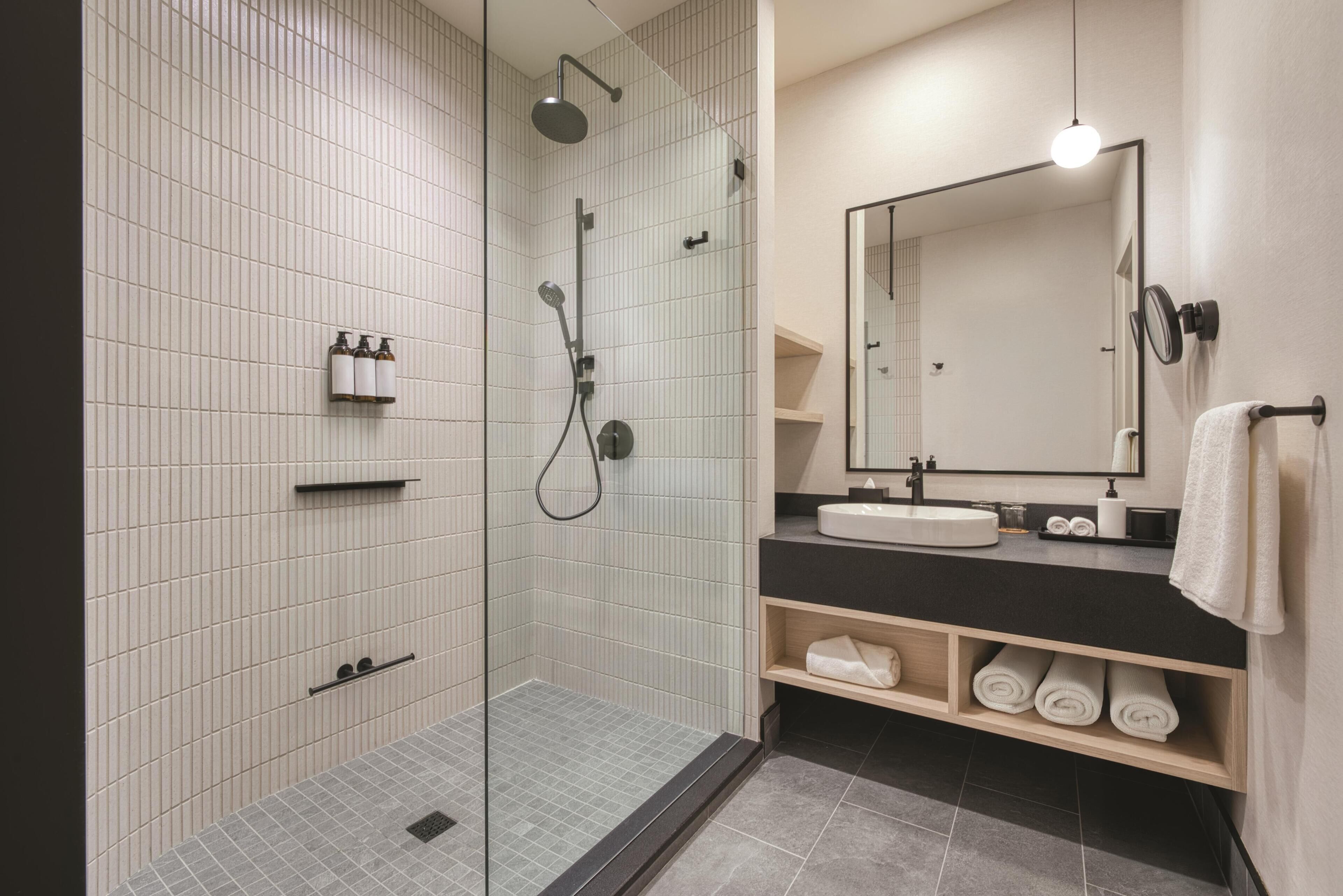 Shower, designer toiletries, hair dryer, slippers