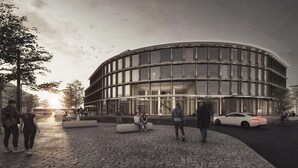 Ein modernes Gebäude mit einer geschwungenen Fassade, einem Restaurantschild und einer gepflasterten Fläche mit Menschen und Autos.