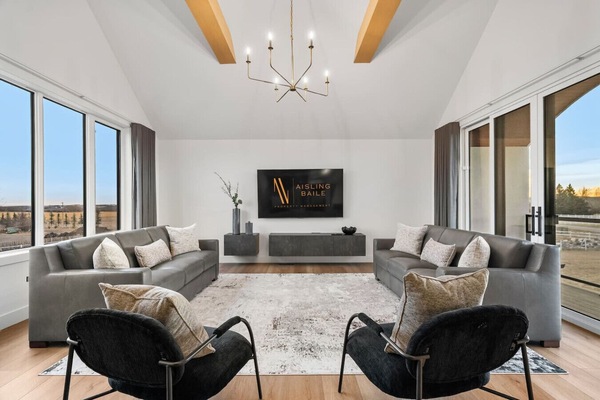 Loft/second living room above the garage with a Smart TV, west-facing balcony with Rocky Mountain views, and two queen-sized sleeper sofas with all bedding provided.