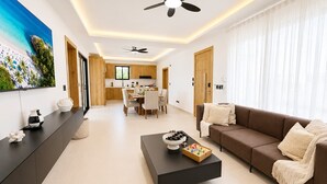 A modern living room with a sofa, coffee table, and a TV on the wall. - Modern Villa | Pool, Terrace & Sleeps up to 8 (Sosúa)