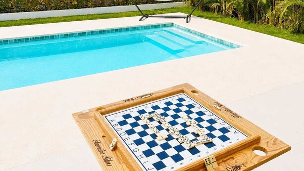 A poolside area with a checkered board game table, a hammock, and a pool. - Modern Villa | Pool, Terrace & Sleeps up to 8 (Sosúa)