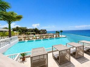 A pool with lounge chairs and a view of the ocean. - Sunset Villa | Bunk Room, Pool & Sleeps up to 11 (Sosúa)