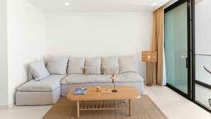 A modern living room with a light grey sectional sofa, a wooden coffee table, and a woven floor lamp. - D432 Very beautiful apartment with a balcony (Cole Bay)