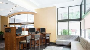 A business center with three computer stations, a reception desk, and a seating area with a view of the outdoors. - Near Independence Hall + Free Breakfast. Bar. Gym. (Philadelphia)