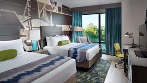 A hotel room with two beds, a desk, a chair, and a large window with curtains. - Near The University of Alabama + Restaurant & Bar (Tuscaloosa)