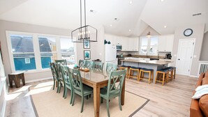 A spacious kitchen with a large island, white cabinets, and a view of the outside. - Semi-Oceanfront, Ocean Views, Priv. Pool, Hot Tub-WL922, Beauty and the Beach (Corolla)
