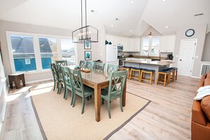 A spacious kitchen with a large island, white cabinets, and a view of the outside. - Semi-Oceanfront, Ocean Views, Priv. Pool, Hot Tub-WL922, Beauty and the Beach (Corolla)