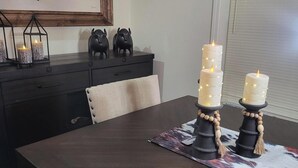 A dining table with a dark wood finish, a framed artwork above it, and a window with blinds to the right. - Ride from your door Atv Trails & Swim,Fish in Tug Hill Plenty of Trailer Parking (Redfield)