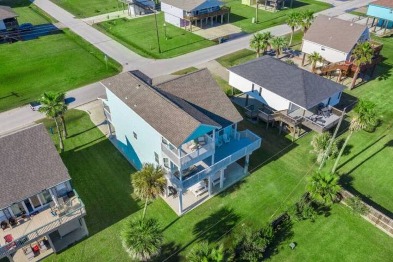 A two-story house with a balcony and a pool.