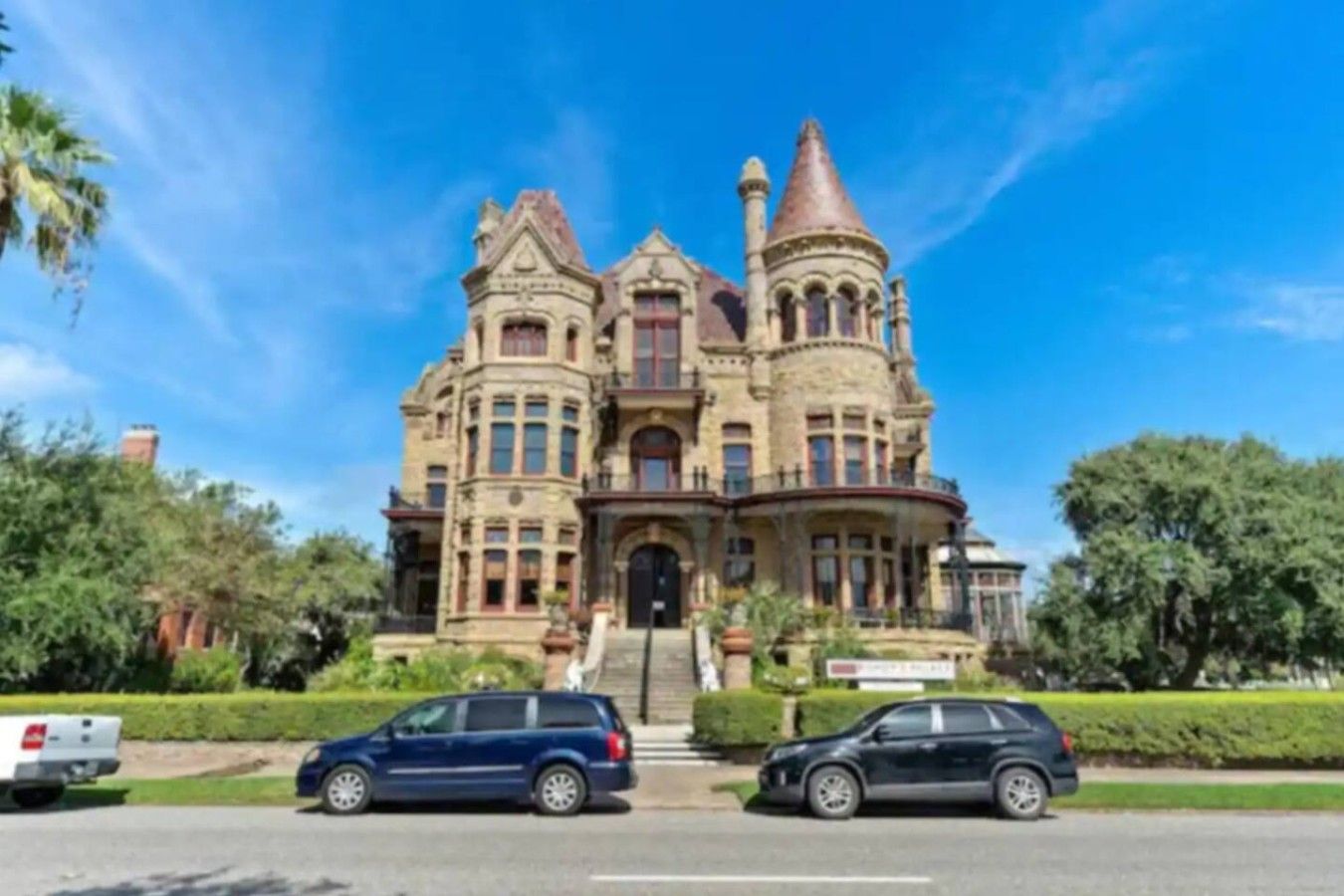 A large, historic building with multiple towers and a prominent entrance.