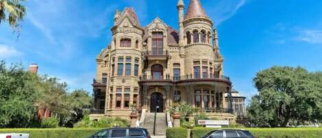A large, historic building with multiple towers and a prominent entrance.