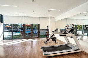 A gym with a treadmill, stationary bike, and exercise equipment. - 17West 3BR Miami Beach | Pool & Walk to Beach (Miami Beach)