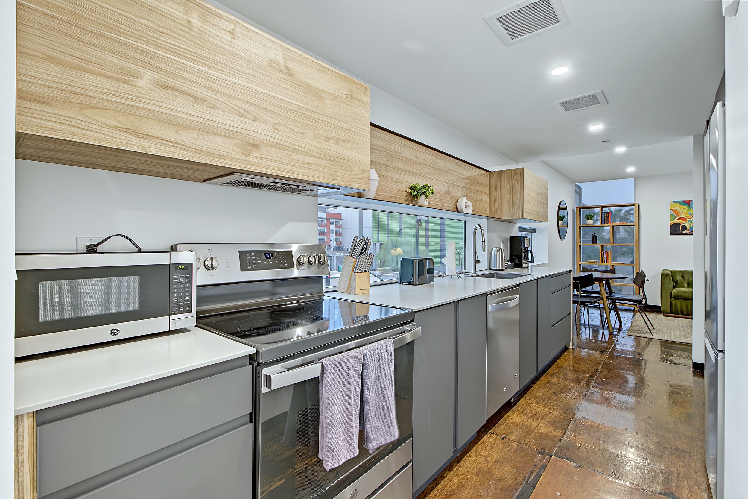 A modern kitchen with a built-in oven, microwave, and stainless steel appliances.