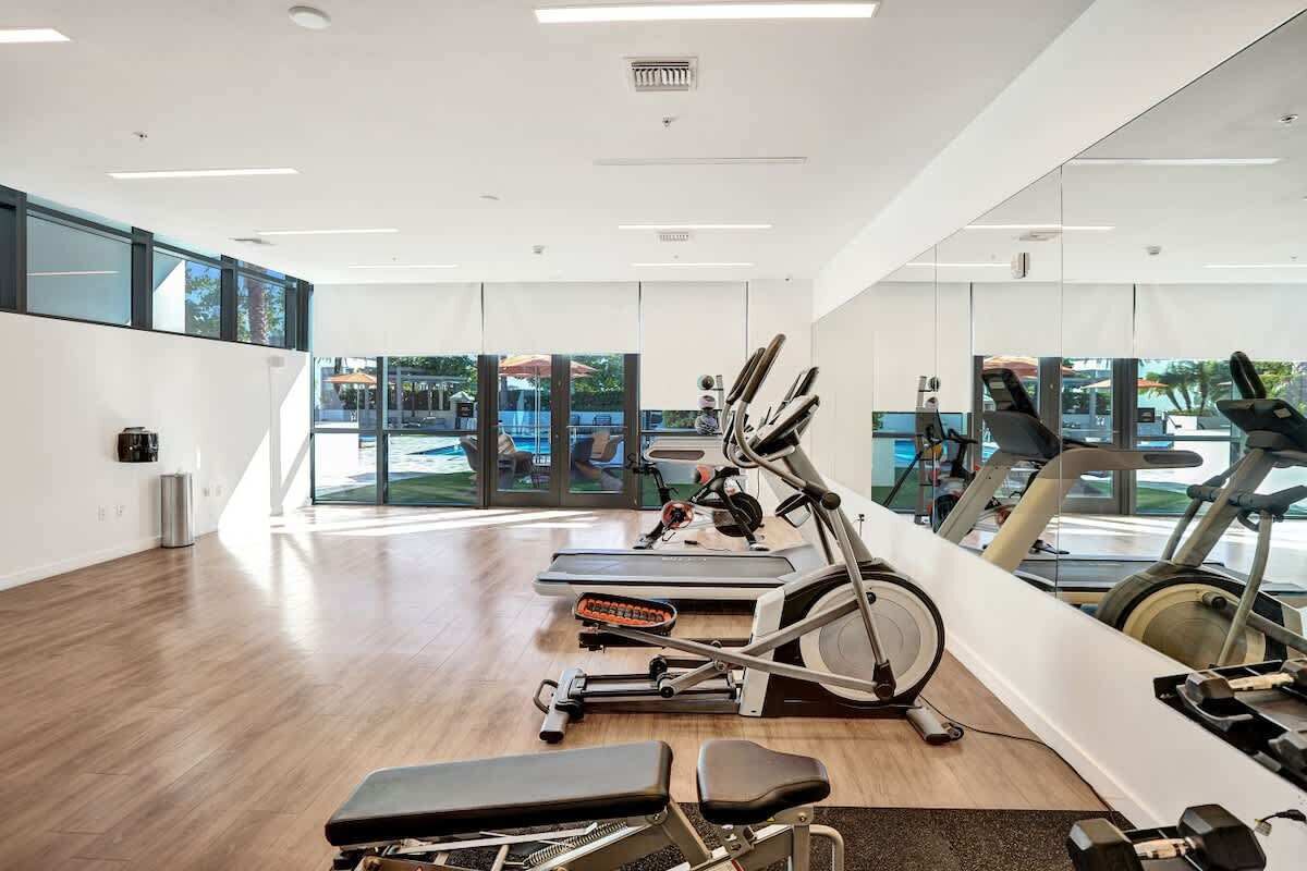 Gym with exercise bikes, cardio equipment and mirrored walls